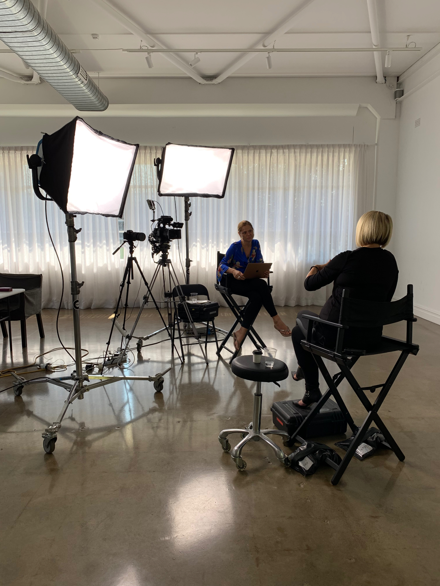 Behind the scenes, Rebecca Maklad on set during a podcast interview